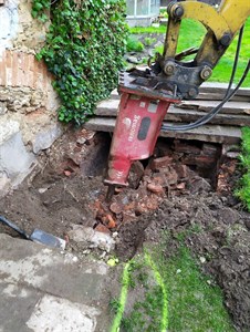 Bourací kladivo rozbíjí cihlový základ